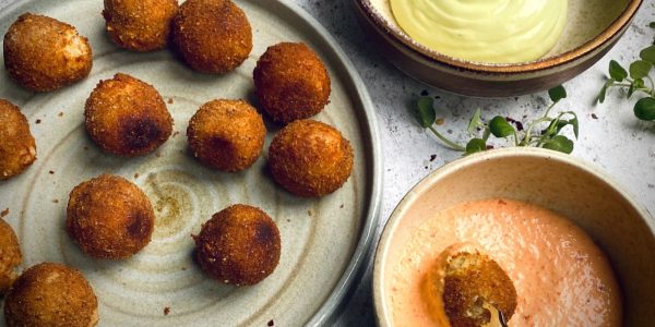 Tunworth croquettes on a plate with two dips in bowls