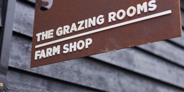 Bronze sign of The Grazing Rooms and Sky Park Farm Shop